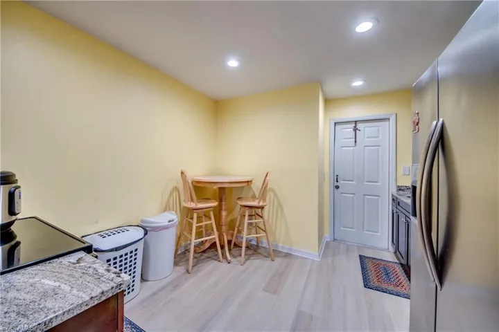Kitchen featuring stainless steel fridge and light hardwood / wood-style floors