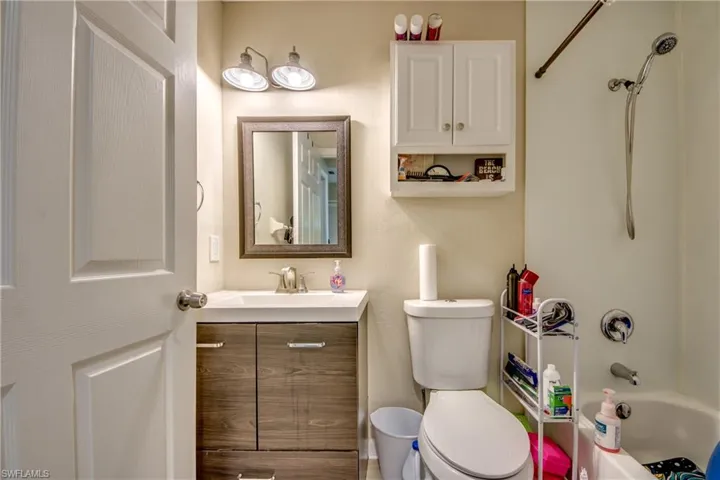 Full bathroom with vanity, shower / bathtub combination, and toilet