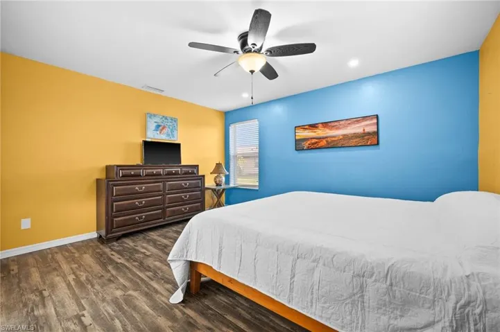 Bedroom featuring ceiling fan and dark hardwood / wood-style flooring