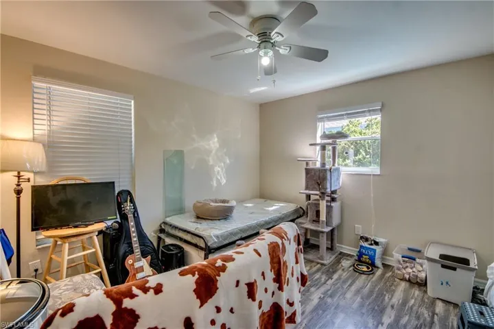 Bedroom featuring ceiling fan and dark hardwood / wood-style flooring