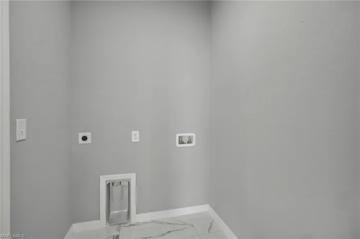 Laundry room featuring hookup for a washing machine, hookup for an electric dryer, and tile patterned flooring