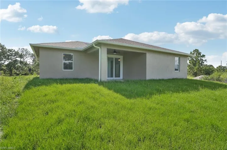 Back of house featuring a yard