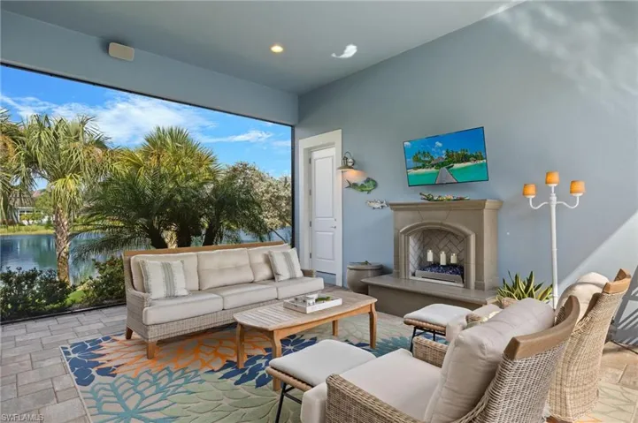 Living room with a water view and exterior fireplace