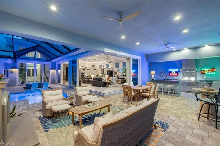 View of patio with ceiling fan, exterior kitchen, outdoor lounge area, and exterior bar