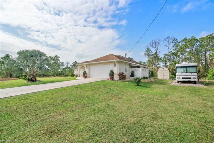 View of front of home with a garage and a front yard