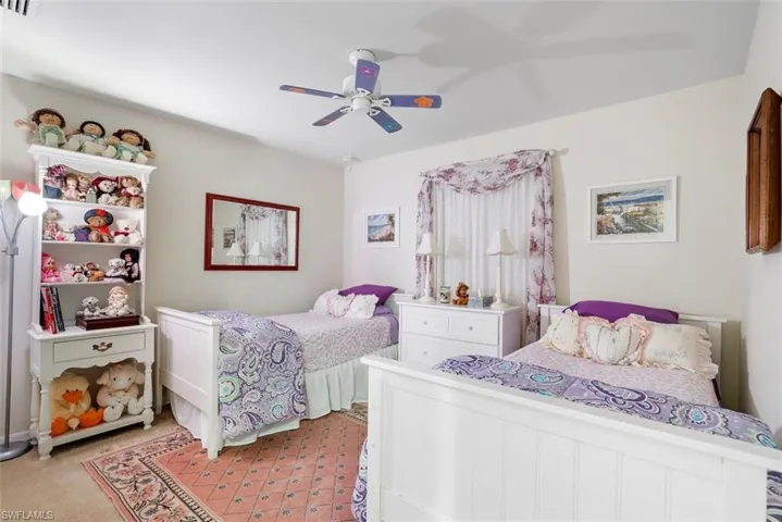 Bedroom featuring ceiling fan and light carpet
