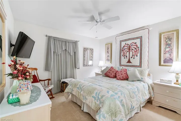 Bedroom featuring ceiling fan and light carpet