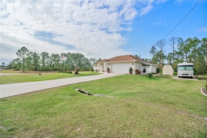 View of front of house with a front lawn and a garage