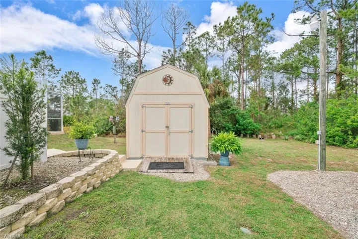 View of outbuilding with a yard