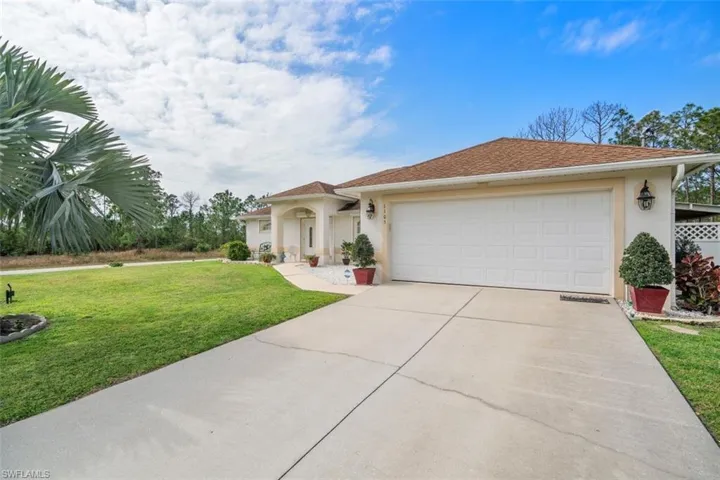 View of front of property featuring a garage and a front yard