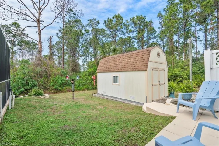View of yard featuring a storage shed and a patio