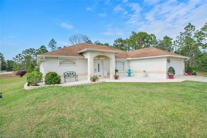 View of front facade with a front yard and a garage
