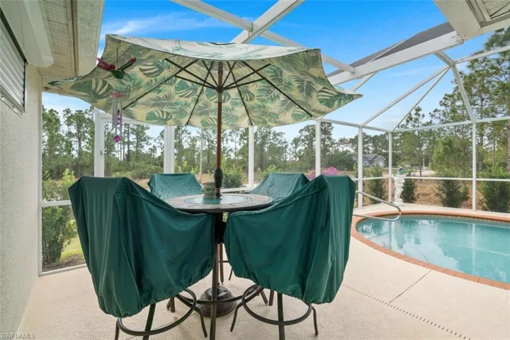 View of pool with a patio and a lanai