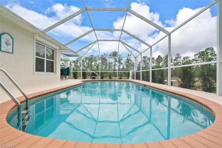 View of swimming pool with glass enclosure