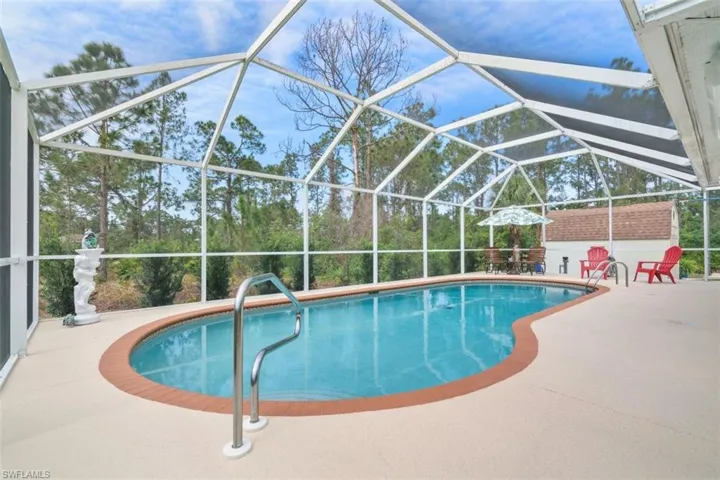 View of swimming pool with a patio and a lanai