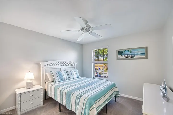 Carpeted bedroom with ceiling fan