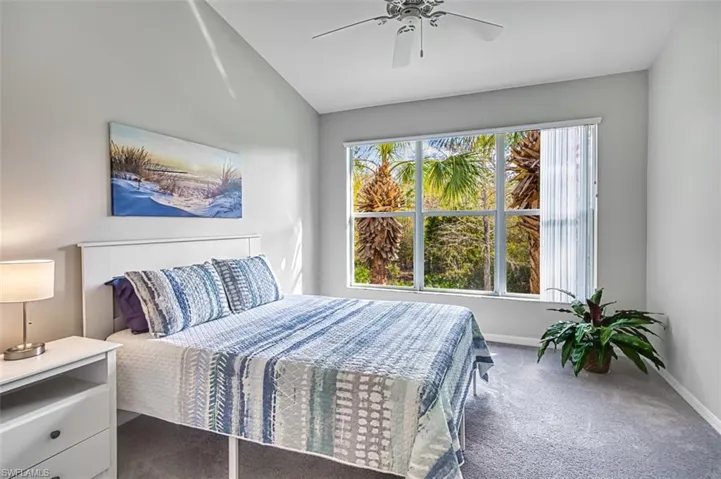 Bedroom featuring carpet, vaulted ceiling, and ceiling fan