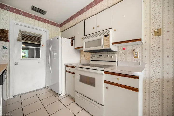 White cabinetry with wood trim accents