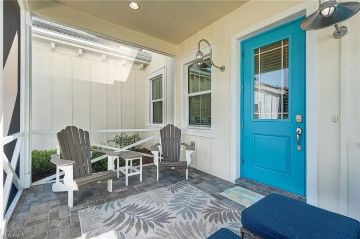 Property entrance featuring a sunroom and board and batten siding