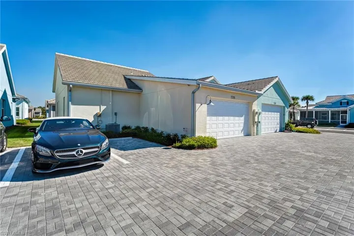 Single story home with a tiled roof, stucco siding, and a garage