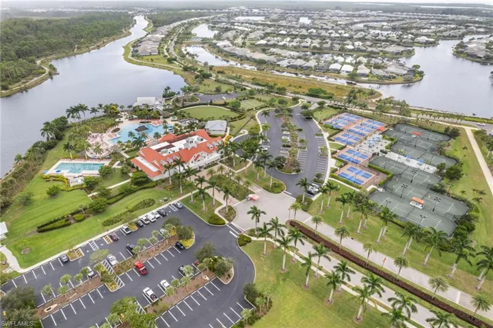 Aerial view of property and surrounding area with a nearby body of water
