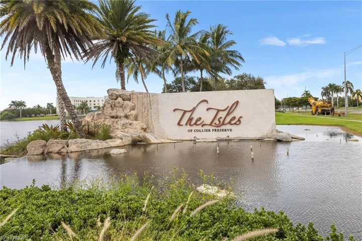 Community / neighborhood sign featuring a water view