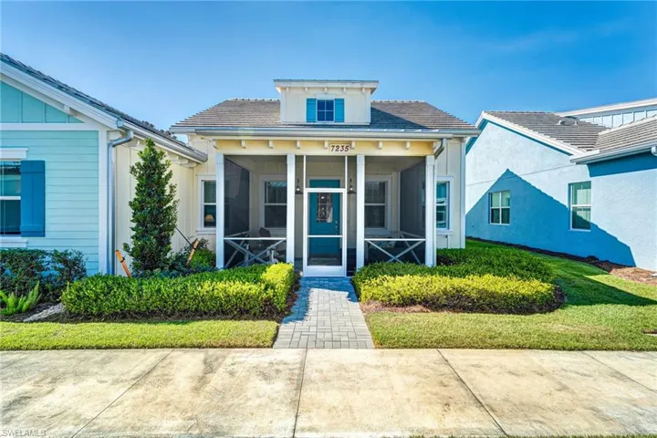 Bungalow-style home featuring a sunroom and a front yard