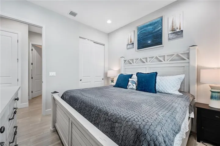 Bedroom featuring light wood-style flooring, a closet, and recessed lighting