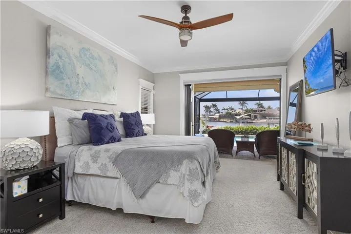 Bedroom featuring carpet floors, crown molding, and visible vents