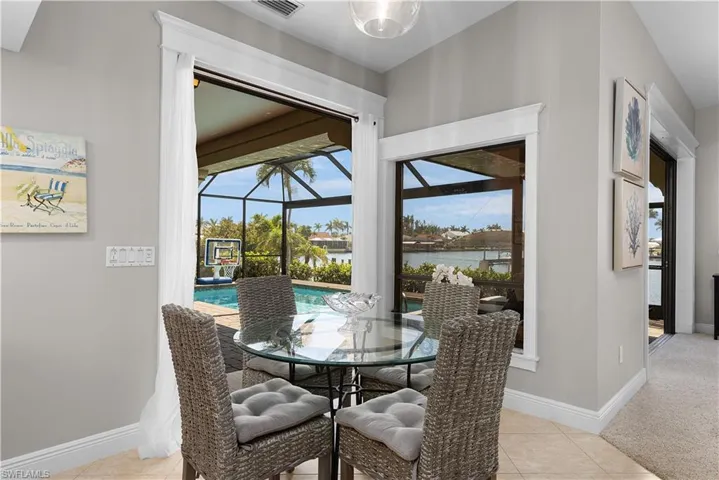 Carpeted bedroom with ceiling fan, baseboards, ornamental molding, access to exterior, and visible vents