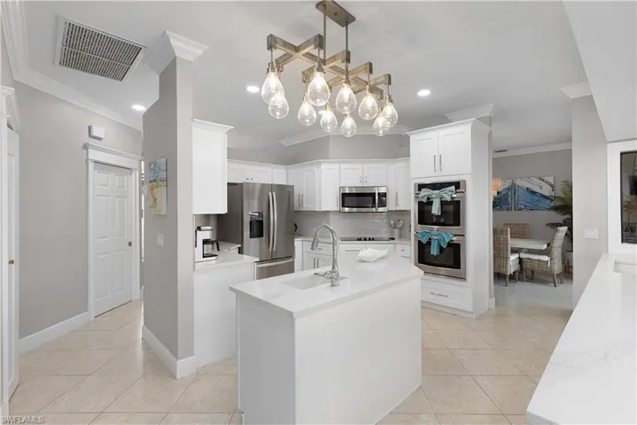 Office area featuring built in study area, ornamental molding, baseboards, and ceiling fan
