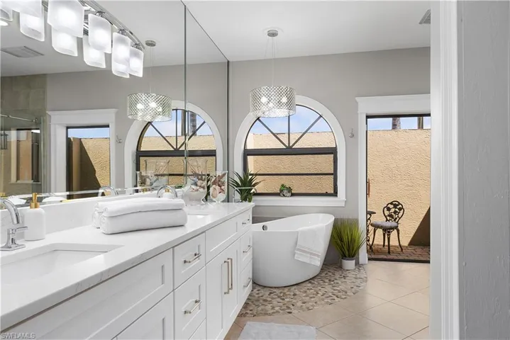 Full bath with a shower stall, a soaking tub, and tile patterned flooring