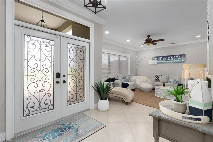 Carpeted living area featuring ceiling fan, vaulted ceiling, visible vents, and recessed lighting