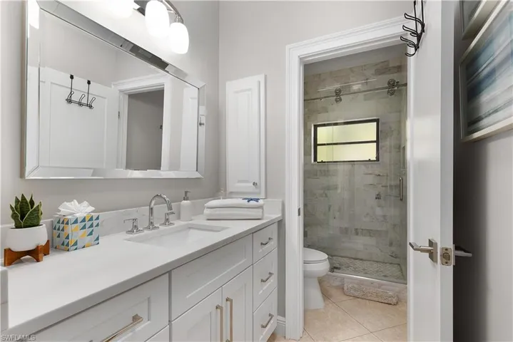 Laundry area with cabinet space, washing machine and dryer, ornamental molding, and a sink