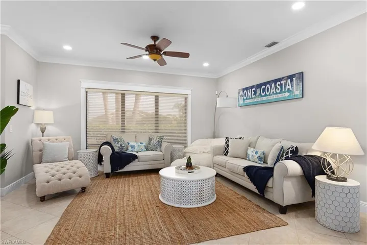 Bedroom with carpet floors, ceiling fan, and crown molding