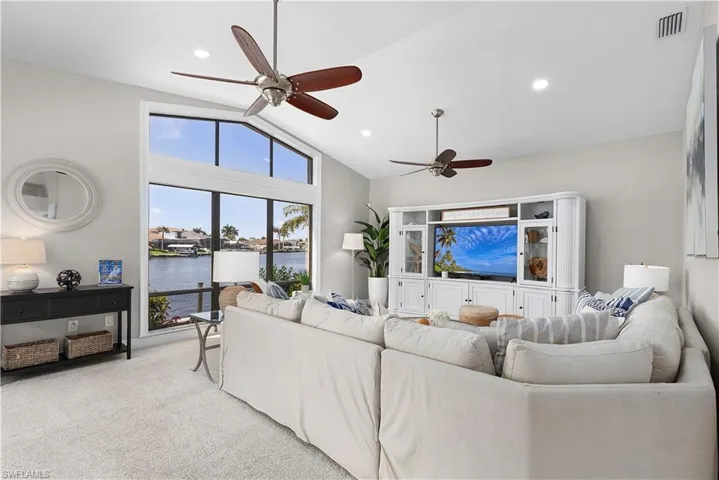 Kitchen with a sink, light tile patterned floors, stainless steel appliances, backsplash, and ornamental molding