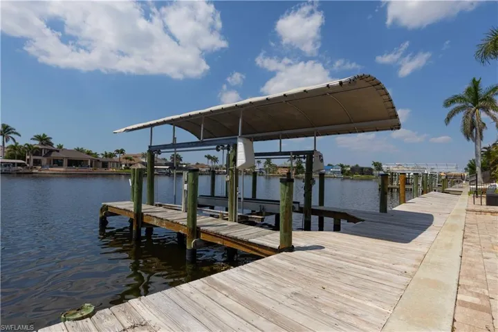 Dock area with a water view and boat lift