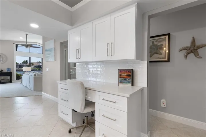 Kitchen with ornamental molding, baseboards, appliances with stainless steel finishes, and visible vents
