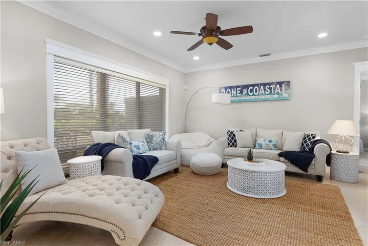 Bedroom with baseboards, crown molding, and carpet flooring