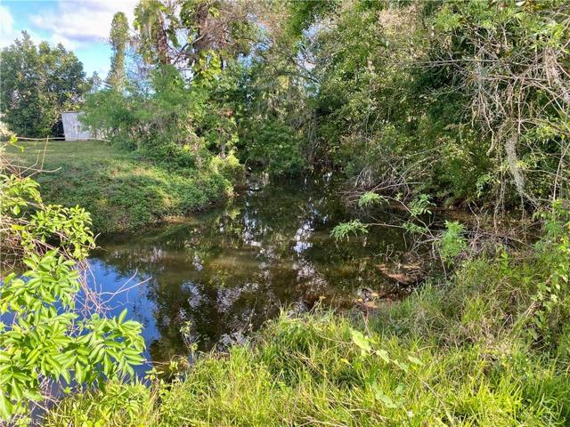The home has a small creek on one side