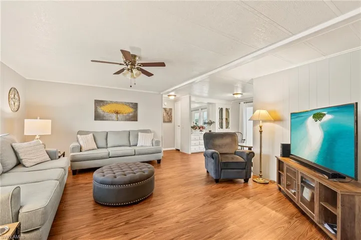 Living room with hardwood / wood-style floors and ceiling fan