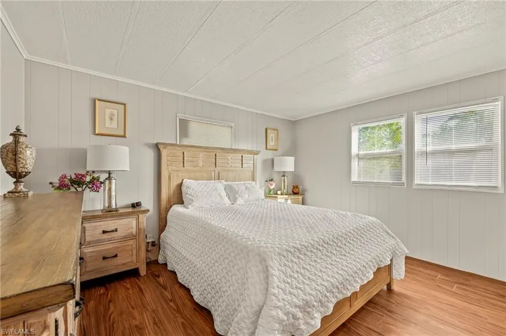 Bedroom with wood-type flooring and ornamental molding