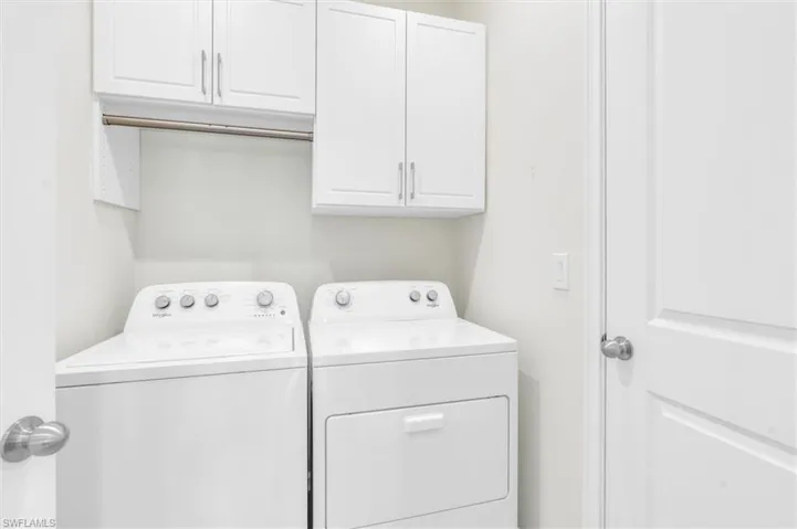 Hanging bar and cabinet space to store items.