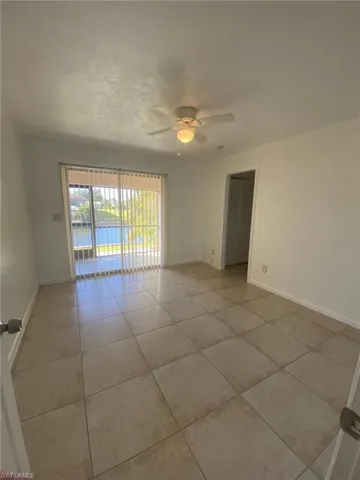 Master bedroom features lighted ceiling fan and adjoining Bath