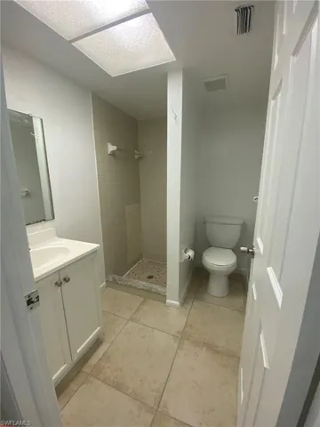 Tiled Master bath with single vanity.