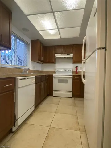 Kitchen features dishwasher, range and refrigerator