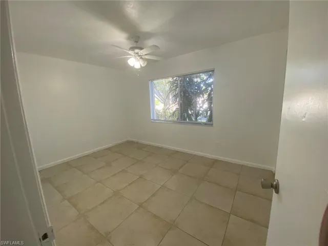 Tiled Front Guest room with lighted ceiling fan