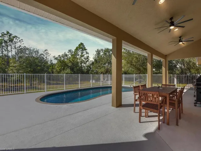 View of pool with a patio area, outdoor dining space, a fenced backyard, and a grill