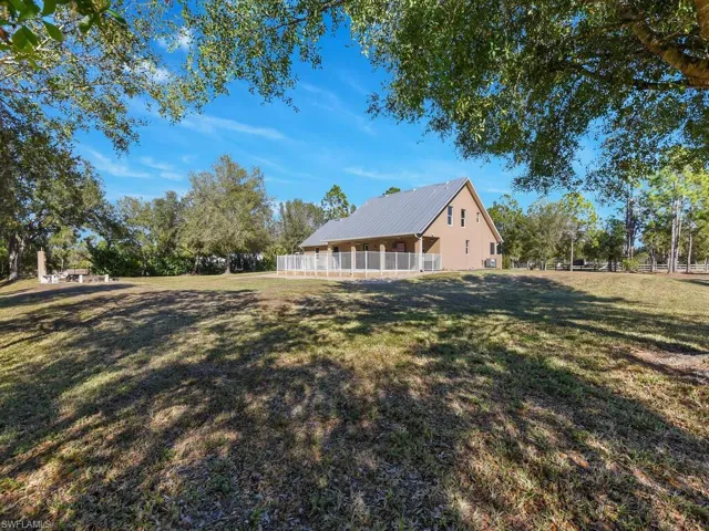 View of side of property with a metal roof
