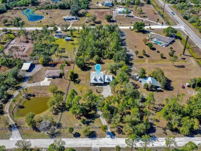 Aerial view of property's location with a nearby body of water